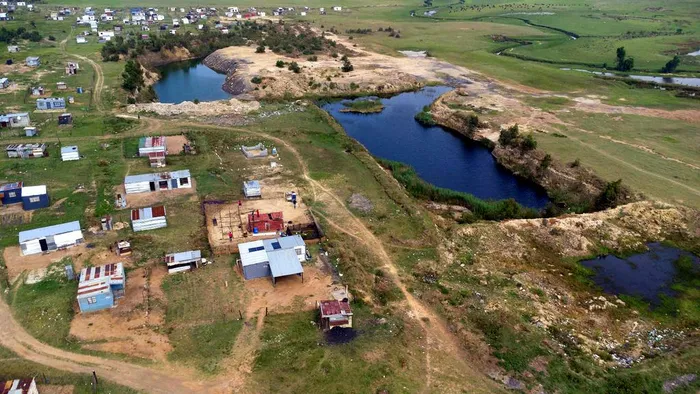 Inhabitants live near a former open-pit coal mine in Mpumalanga.