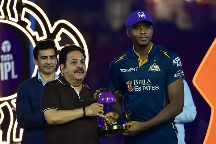 Gujarat Titans' South African cricket player Kagiso Rabada (R) is awarded the "Purple Cap" by Board of Control for Cricket in India (BCCI) vice president Rajeev Shukla during the presentation ceremony at the end of the 2026 Indian Premier League (IPL) T20 final match between Gujarat Titans and Royal Challengers Bengaluru in the Narendra Modi Stadium of Ahmedabad on June 1, 2026. Picture: Shammi MEHRA / AFP