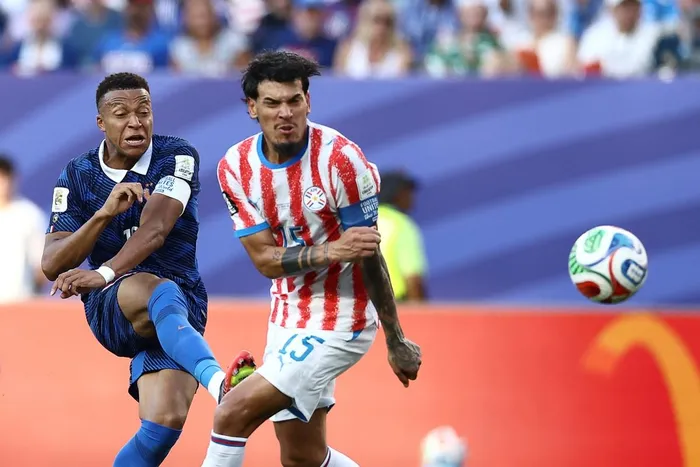 France's forward Kylian Mbappe and Paraguay's defender Gustavo Gomez fight for the ball during the 2026 World Cup round of 16 football match between Paraguay and France at the Philadelphia Stadium in Philadelphia on July 4, 2026.
