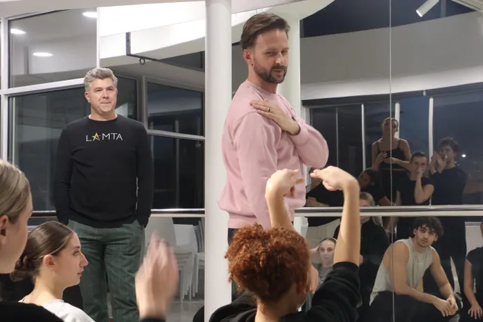 Duane Alexander (right) and Anton Luitingh (left) in rehearsal with the students preparing for ‘Killer Queen’ theatre show. 