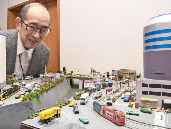 Masao Oka views a diorama featuring a tram that he built.