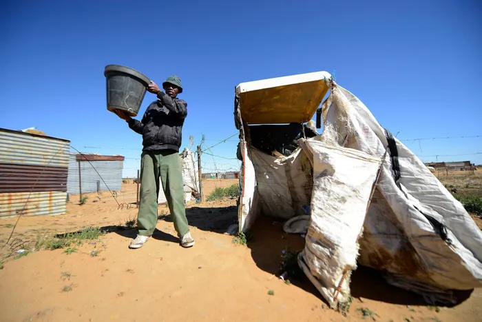 Gert Molefi from Rammulutsi in the Free State shows the bucket used in the community. Picture:Paballo Thekiso