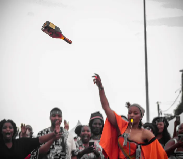 A woman in the Eastern Cape throws a bottle of Hennessy in the air during her son’s Umgidi and sparked a debate about the relevance of the Xhosa initiation tradition. MG Photography/Facebook