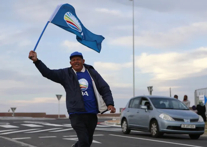 A Democratic Alliance(DA) supporter waves the party's flag
