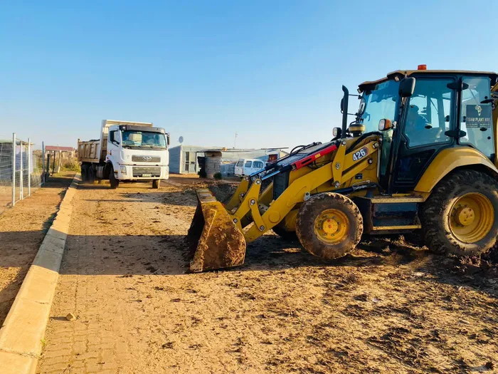 Trucks on site working while the contractor and government are at loggerheads over the project