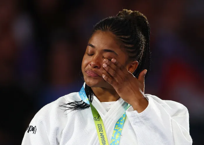 Gold medallist South Africa's Michaela Whitebooi reacts on the podium after winning the women's judo 48kg final on Monday