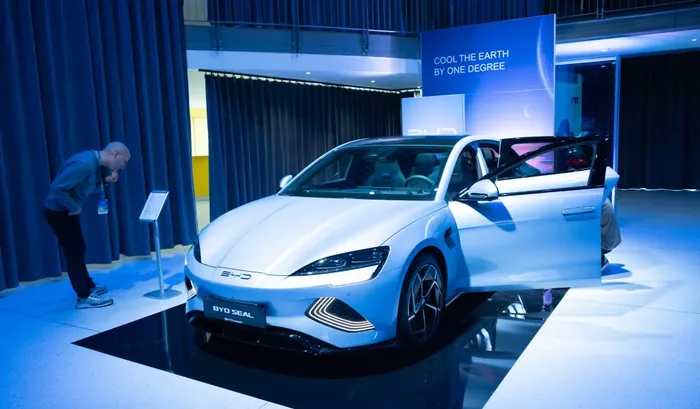 A man looks at a BYD electric vehicle in Budapest, Hungary, Oct. 17, 2023. Chinese electric vehicle manufacturer BYD has taken a leap in its global expansion by launching the sale of its new energy vehicles in Hungary on Tuesday.
