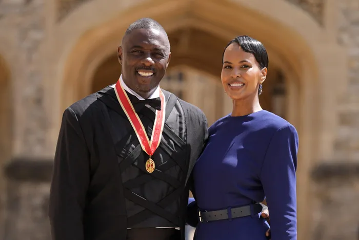 British actor Idris Elba poses with his wife Sabrina Dhowre Elba and his medal after being appointed as a Knight Bachelor (Knighthood) for services to young people at an investiture ceremony at Windsor Castle on June 2, 2026. 