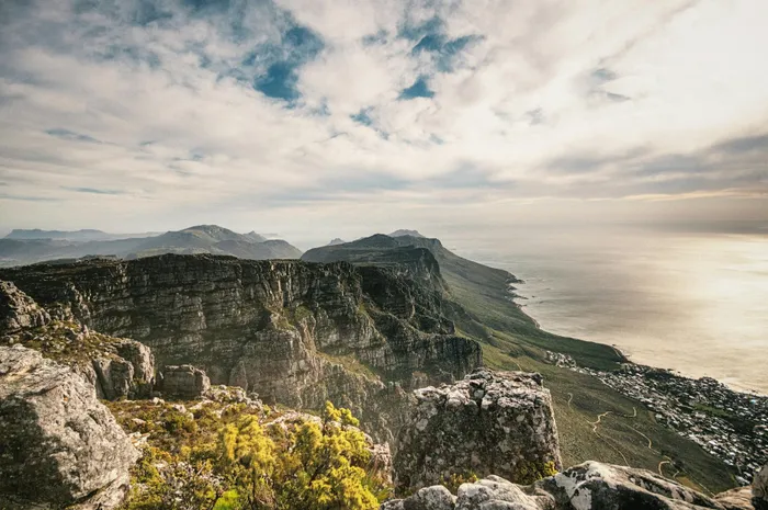 A stunning bird's-eye perspective of Table Mountain in South Africa, showcasing its dramatic cliffs and the expansive ocean.