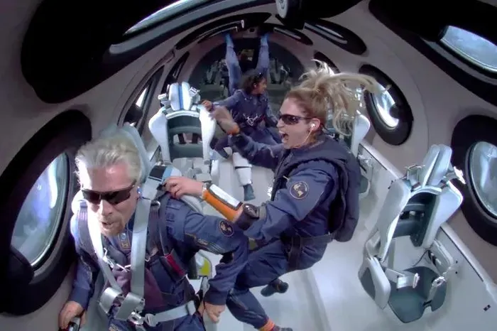 Billionaire Richard Branson makes a statement as crew members Beth Moses and Sirisha Bandla float in zero gravity on board Virgin Galactic's passenger rocket plane VSS Unity. The company is being engage to test the effects of menstruation in female astronauts in space.