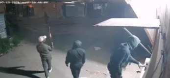 A screenshot from CCTV footage circulating on social media shows armed men entering a Crossroads spaza shop while customers are inside. Moments later, shoppers are seen fleeing and the business closes.