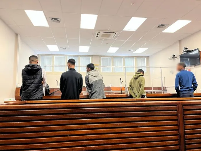 Five suspects appeared at the Wynberg Magistrate’s Court yesterday charged with robbery with aggravating circumstances. They were found in possess of items belonging to German national, Nick Frischke. Picture: Mthuthuzeli Ntseku/Cape Argus