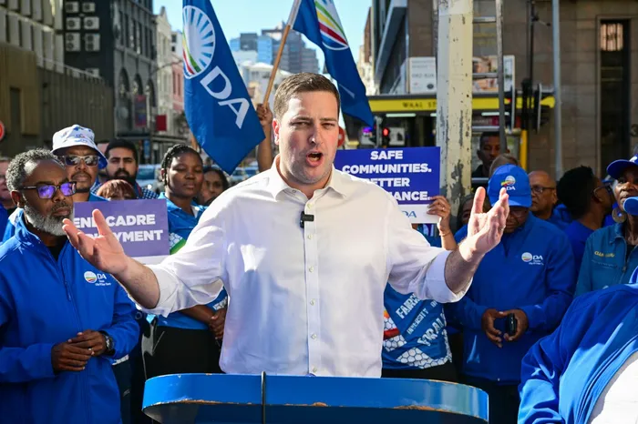 Geordin Hill-Lewis hangs Democratic Alliance (DA) election campaign posters in Wale Street, Cape Town, as the party launches its campaign ahead of the upcoming local government elections.