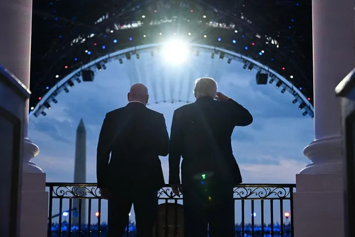 US President Donald Trump and UFC CEO Dana White stand on the Blue Room Balcony of the White House as US military jets perform a flyover during the "UFC Freedom 250" mixed martial arts event in Washington, DC, June 14, 2026. 