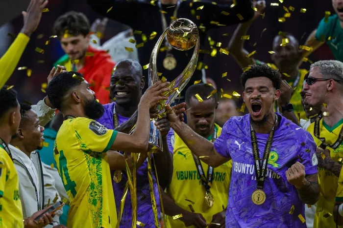 Mamelodi Sundowns' players celebrate with their winning trophy at the end of the CAF Champions League final football match against AS FAR at the Prince Moulay Abdellah Stadium in Rabat on May 24, 2026.