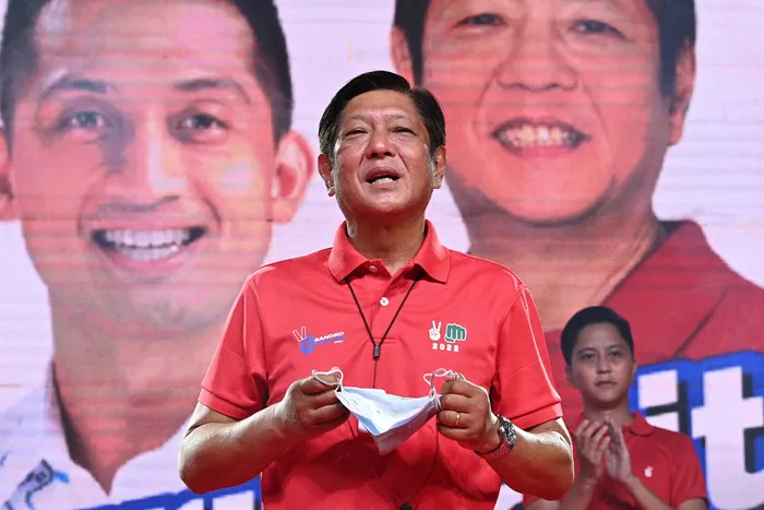 Presidential candidate Ferdinand Marcos jr delivers a speech last month prior to introducing his son Ferdinand Alexander ‘Sandro’ Marcos, back, during a rally in Laoag, north of Manila. Picture: Ted ALJIBE/AFP