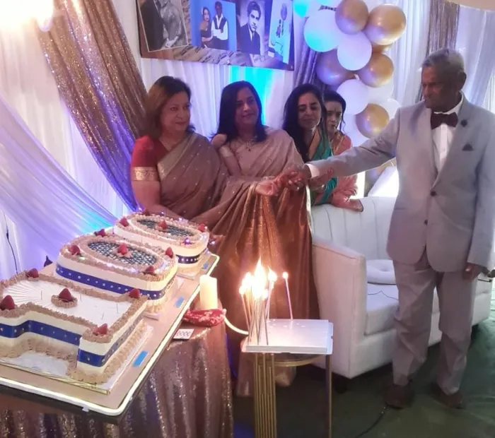 Dennis Naidu is pictured with his daughters at his 100th birthday party last weekend