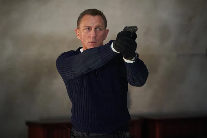 James Bond (Daniel Craig) prepares to shoot in ’No Time to Die’. Picture: Nicola Dove/Danjaq, LLC and MGM