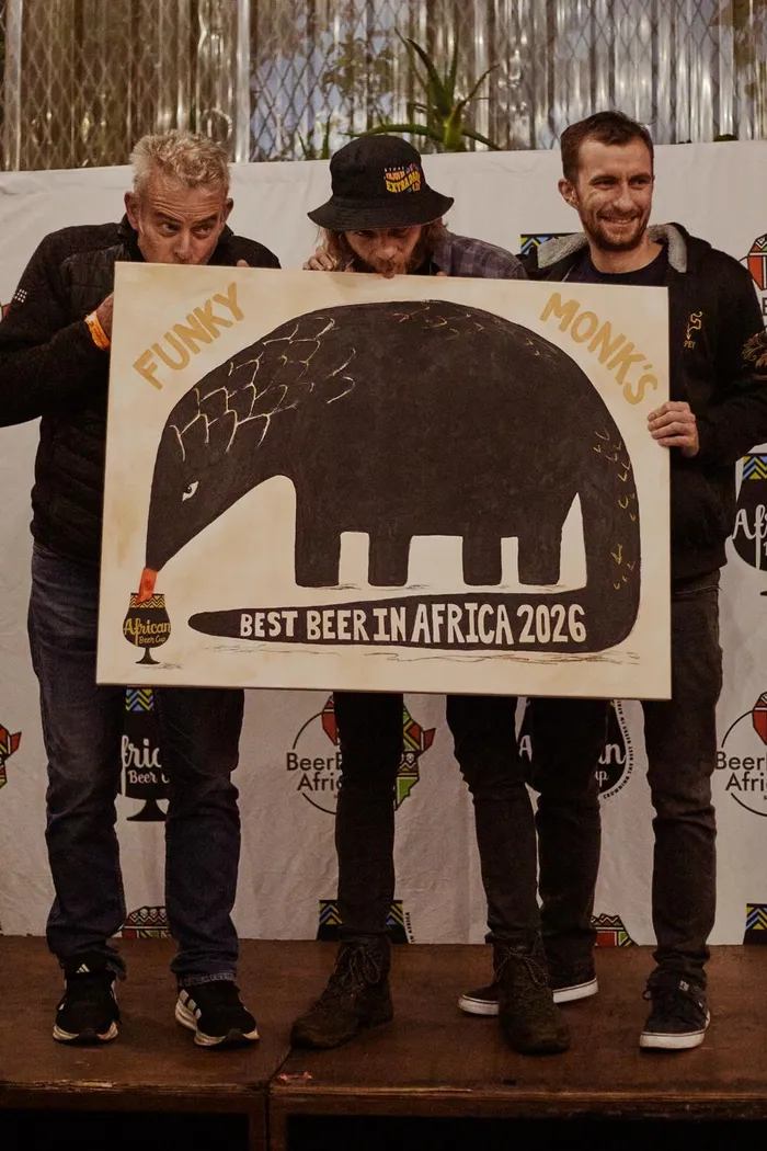 The Woodstock Brewery team celebrate with their custom painting created by Maggie Murray of Carvel.