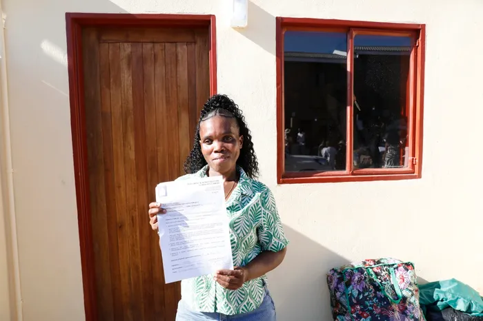 Noloyiso Mafanya beams with happiness as she receives the keys to her new home.