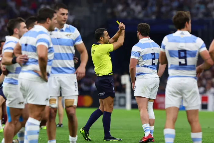 French referee Mathieu Raynal shows the yellow card to Argentina's Santiago Carreras during their Rugby World Cup Pool D match against England