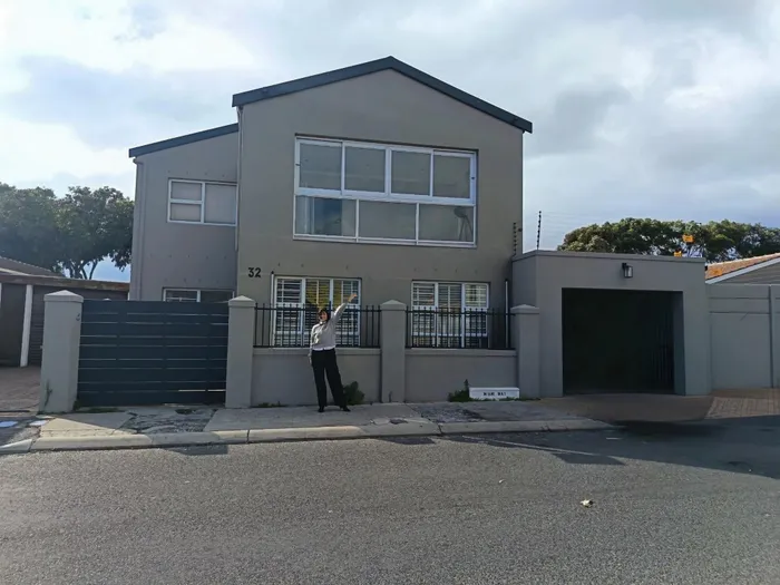 Estate agent Meagan Benjamin outside the Mitchells Plain home she sold for R2.15m.