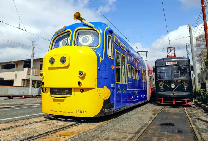 A Chuggington-themed tram car, left, alongside a retro-style car.