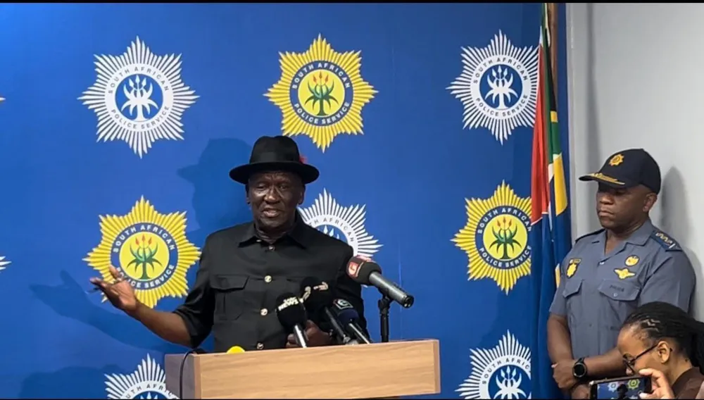 A politician briefs the media about a murder investigation during a press conference.