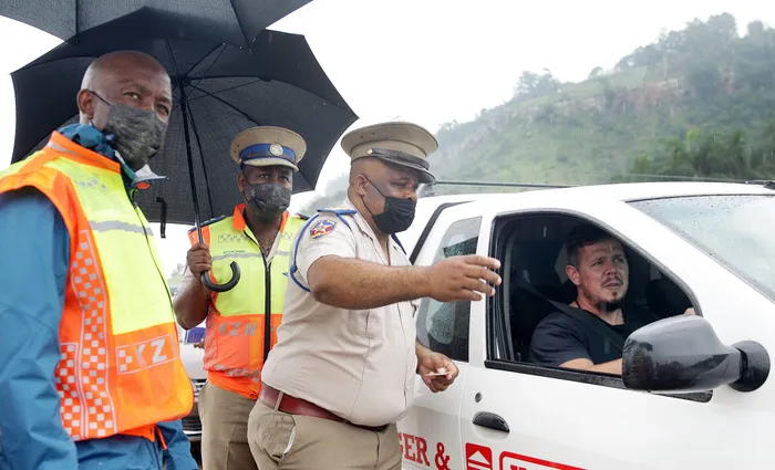 Sboniso Mbhele (left) head of Department of Transport with Thabani Mthembu regional commander at RTI and Ishwar Harilall, station commander at Park Rynie during a safety campaign at Marriannhill toll plaza. Picture: Bongani Mbatha African News Agency /ANA