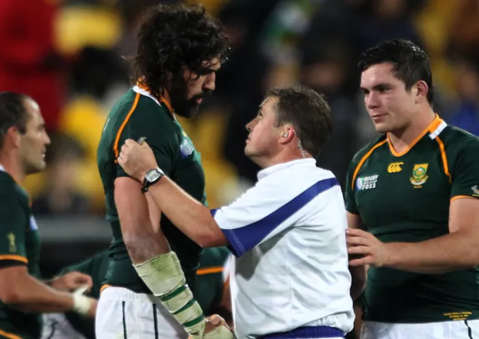 New Zealand referee Bryce Lawrence, middle, shakes the hand of South Africa's Victor Matfield following their Rugby World Cup quarter final in Wellington, New Zealand.