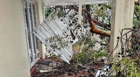 Broken ceiling panels and debris scattered across the floor at Sisters Incorporated in Cape Town after storm damage caused structural collapse inside the shelter.