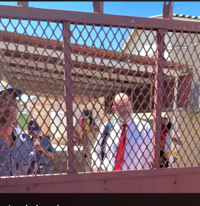 Police protect magistrate Chris Byleveld.