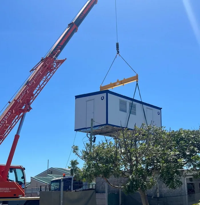 A New mobile operating theatre for the Mdzananda Animal Clinic  is hoisted to replace the old one which was demolished when a truck crashed in it.