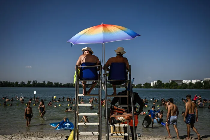 Lifeguards keep watch from their station over a packed lake beach during a heatwave at the Bordeaux Lac beach, in Bordeaux, south-western France on June 23, 2026.