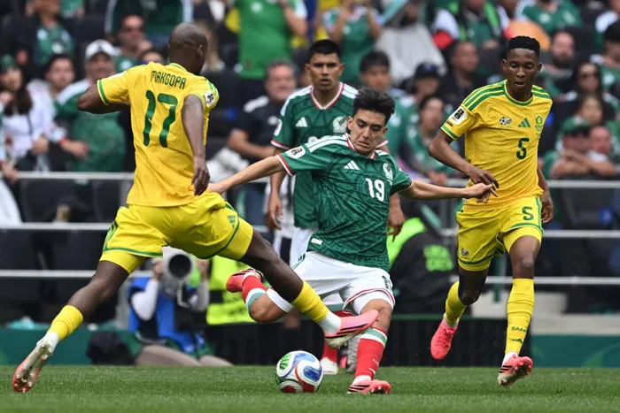 South Africa's forward Evidence Makgopa, Mexico's midfielder #19 Gilberto Mora and South Africa's midfielder #5 Thalente Mbatha fight for the ball during the 2026 World Cup Group A football match between Mexico and South Africa at the Mexico City Stadium in Mexico City on June 11, 2026.
