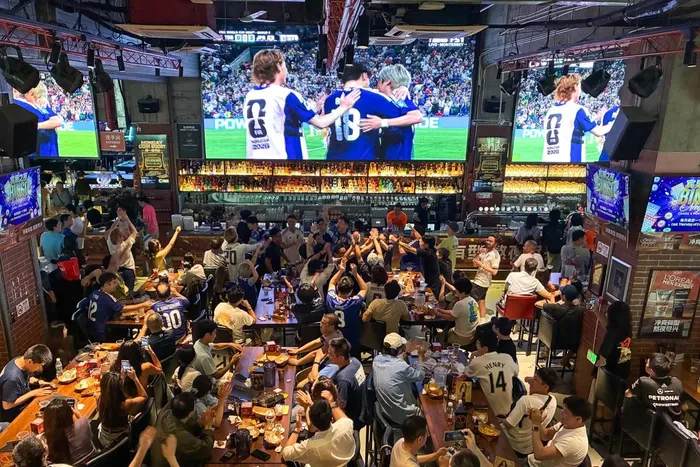 Football fans in Shanghai put regional tensions on the backburner to celebrate Japan's emphatic 4-0 World Cup victory over Tunisia. Photo: AFP