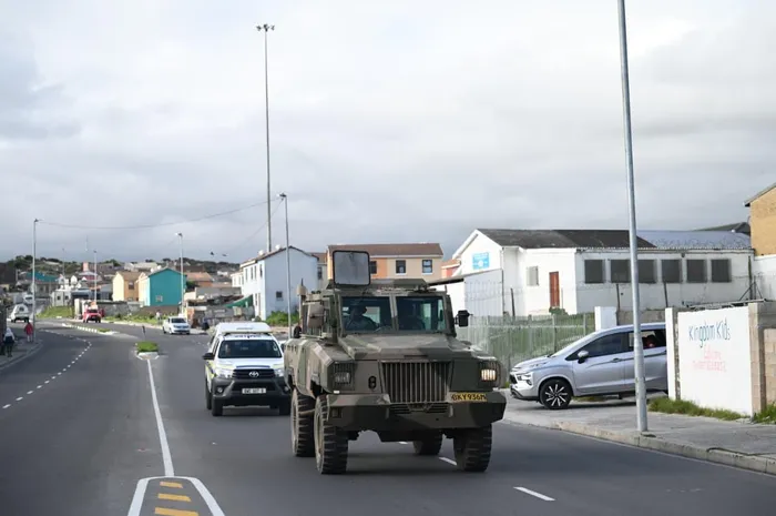 Deputy President Paul Mashatile and law enforcement officials travel through Bainskloof Street in Tafelsig, Mitchells Plain, during an oversight visit linked to Operation Prosper