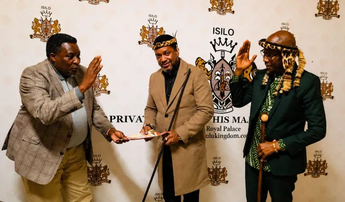 Mpiyakhe Buthelezi, regent of the Buthelezi Traditional Council, receives his appointment letter as the new spokesperson for King Misuzulu kaZwelithini during a ceremony on Tuesday evening, as Inkosi Prince Zuzifa Buthelezi offers a royal salute.