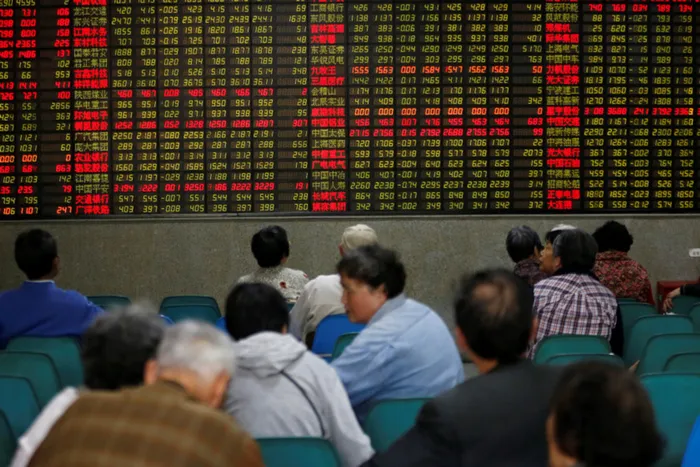 Investors look at an electronic board showing stock information at a brokerage house in Shanghai, China. File picture: Aly Song
