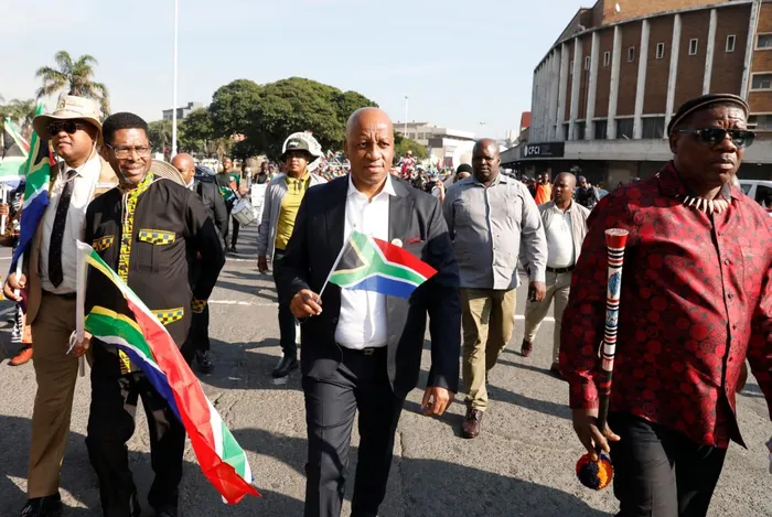 KwaZulu Natal Premier Thami Ntuli, centre, with Economic Development, Tourism and Environmental Affairs MEC Musa Zondi, left, leads the provincial celebration of Africa Day parade in Durban on Monday.