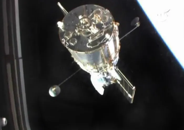 The Hubble Space Telescope is seen in this hand-held video through the aft flight deck window of the space shuttle Atlantis