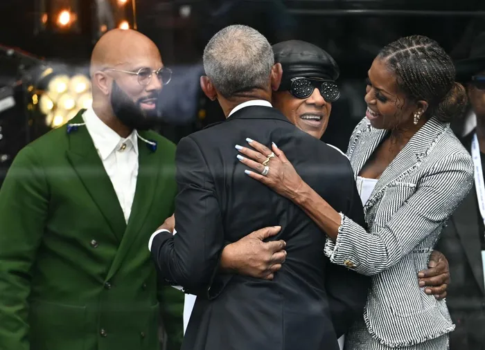 Rapper and actor Common and singer-songwriter Stevie Wonder greet former US president Barack Obama and former first lady Michelle Obama during the opening day of the Obama Presidential Center in Chicago, Illinois, on June 18, 2026.