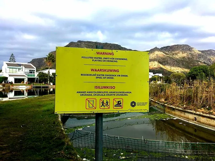 City signage about Zandvlei Estuary pollution.