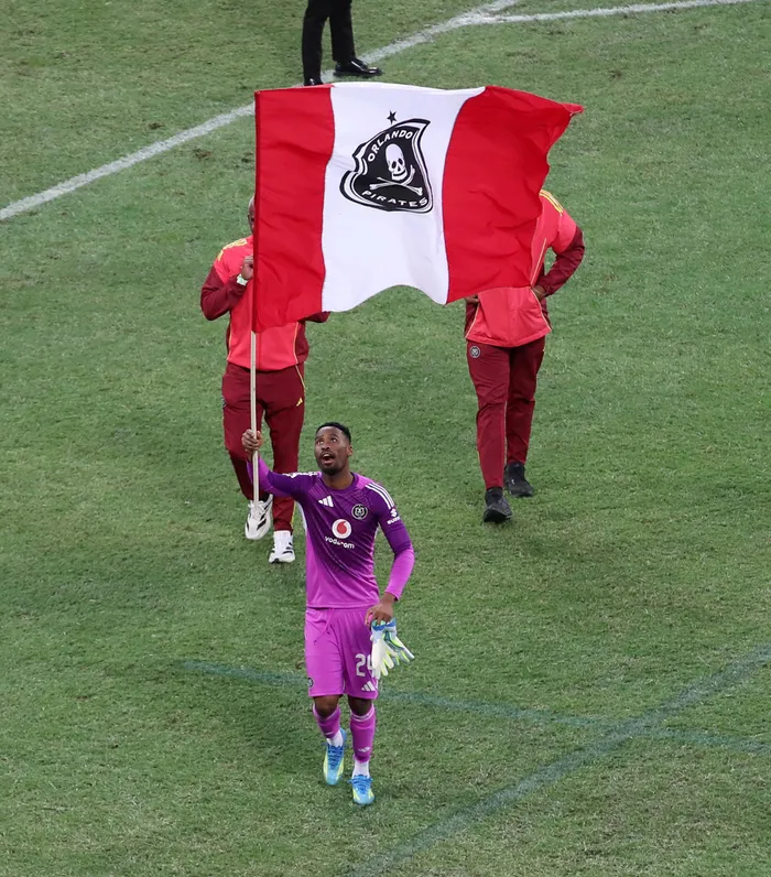 ORLANDO Pirates goalkeeper Sipho Chaine leading celebrations by hoisting the Buccaneers' flag high after they won the Betway Premiership title dethroning Mamelodi Sundowns with a 2-0 against Orbit College in Mbombela Stadium on Saturday. 