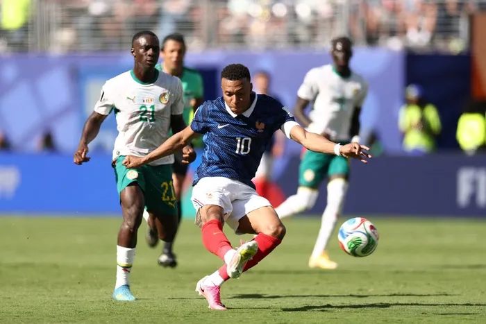 France forward Kylian Mbappe shoots to score his team's third goal during the 2026 World Cup Group I football match against Senegal at the New York/New Jersey Stadium on Tuesday night. 