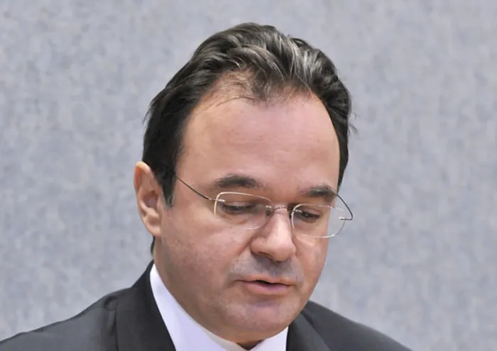 Greek Finance Minister George Papaconstantinou adjusts his microphone during a press conference. Photo: AFP