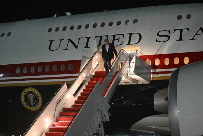 US President Donald Trump disembarks from Air Force One upon arrival at Joint Base Andrews, Maryland on Thursday Trump is returning from the NATO Summit in Turkey. Picture: SAUL LOEB / AFP