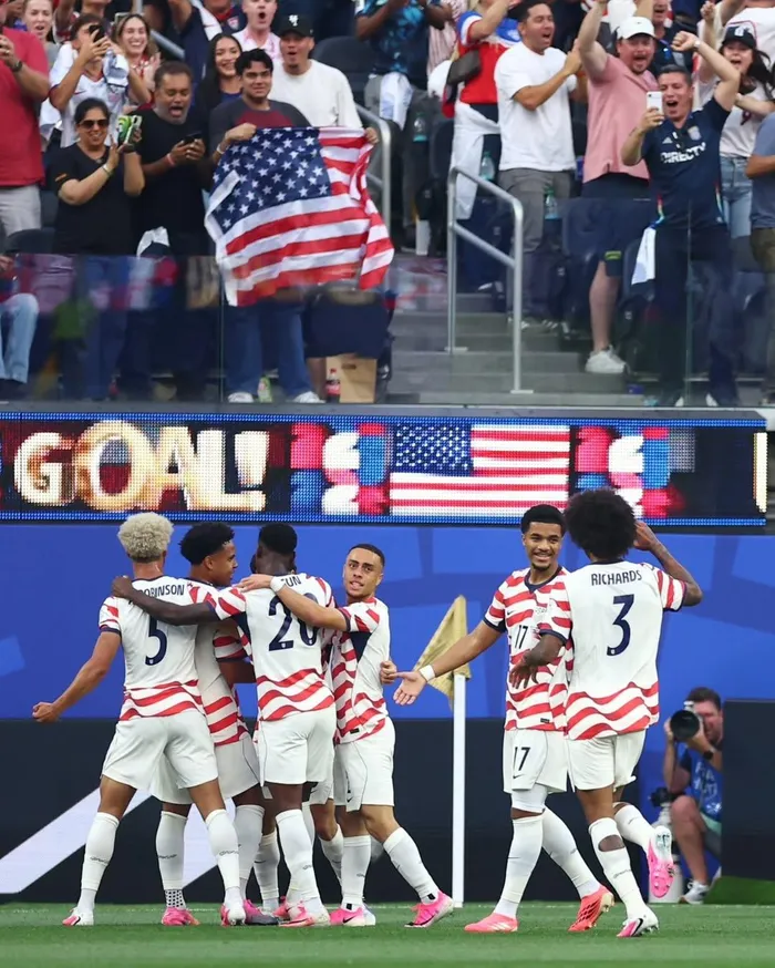 USA join co-hosts into the round of 32 after beating Australia 2-0.