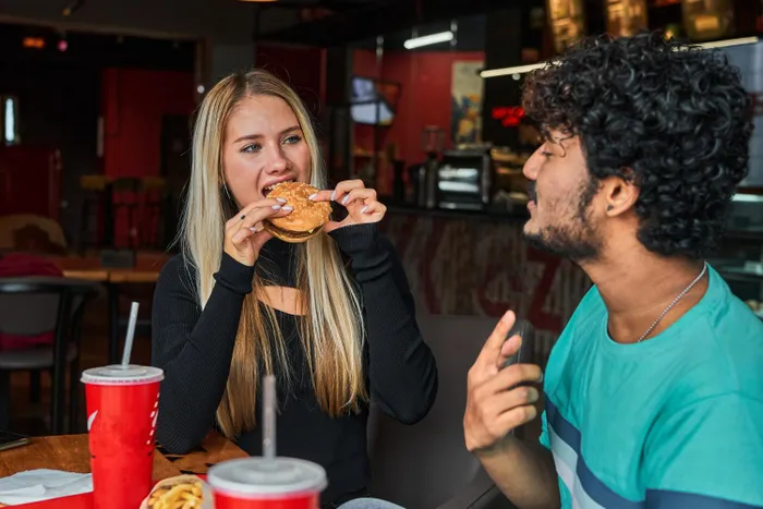 A casual burger outing takes a turn after a man packs his leftovers into a Tupperware container.