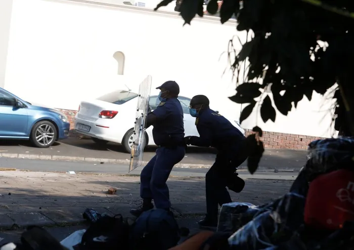 As tensions rise at Durban's Sherwood Hall, clashes break out between police and thousands of displaced Malawian nationals, highlighting a deepening humanitarian crisis.